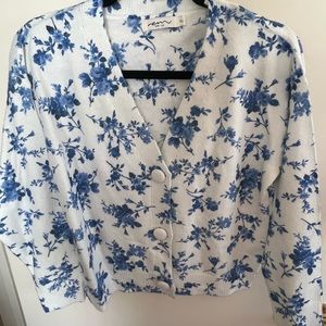 White cardigan sweater with blue floral pattern